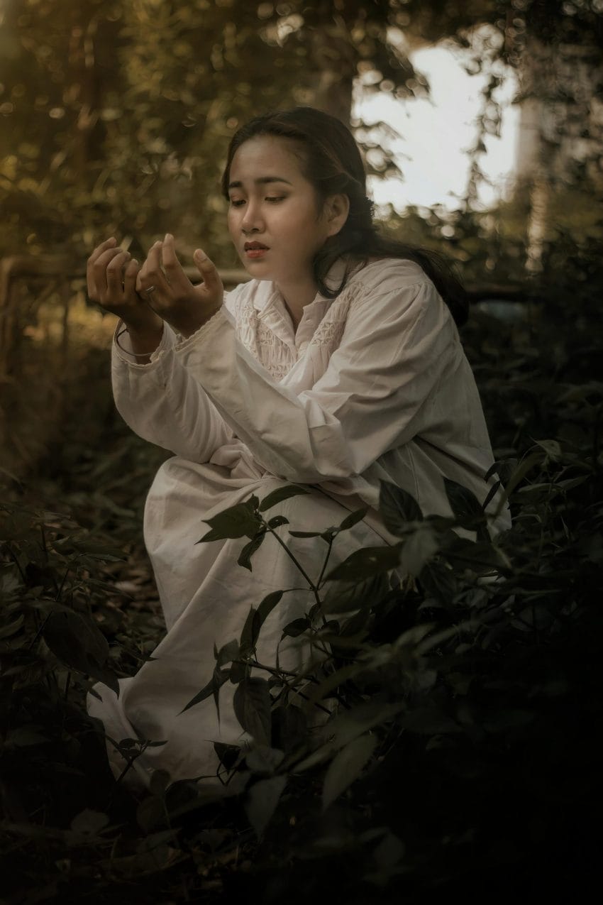 Person practicing gratitude in nature, reflecting on personal growth during a period of stagnation.