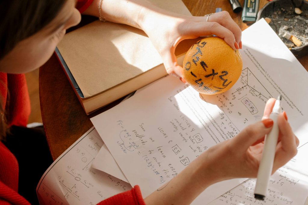Person holding orange round ball