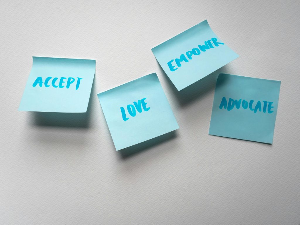 A slogan written on post it notes posted on a white surface